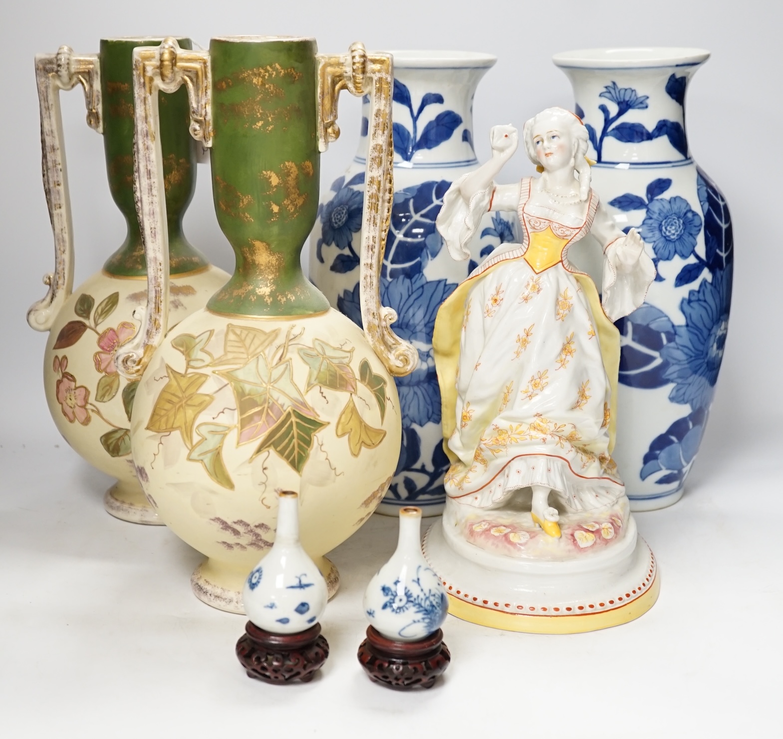 A late 19th century Continental figurine, two pairs of vases and a pair of Japanese miniature vases on stands, tallest 32cm high